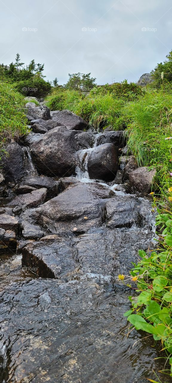 Creek flowing over big rocks