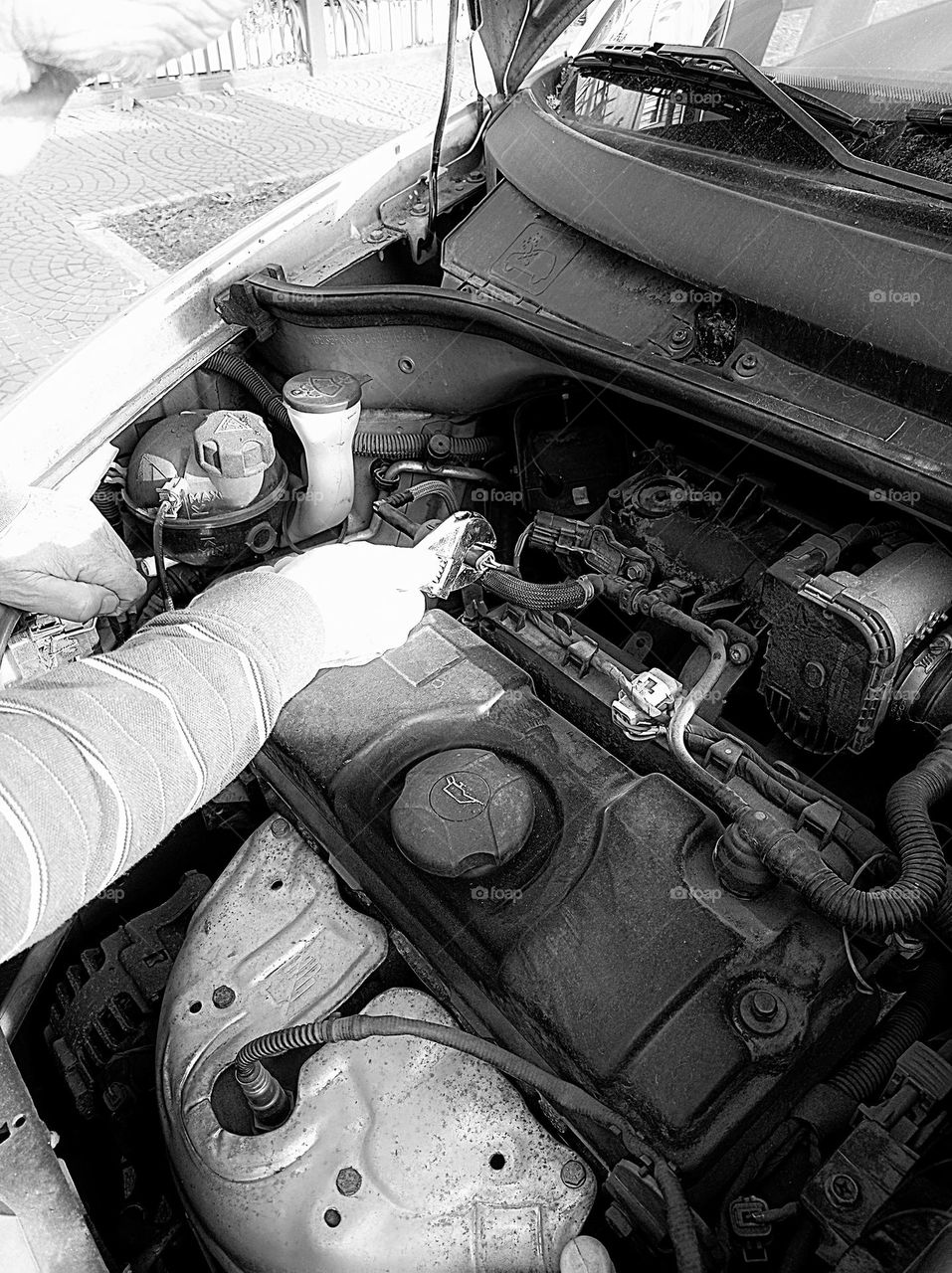 Mechanic's hands working on car engine