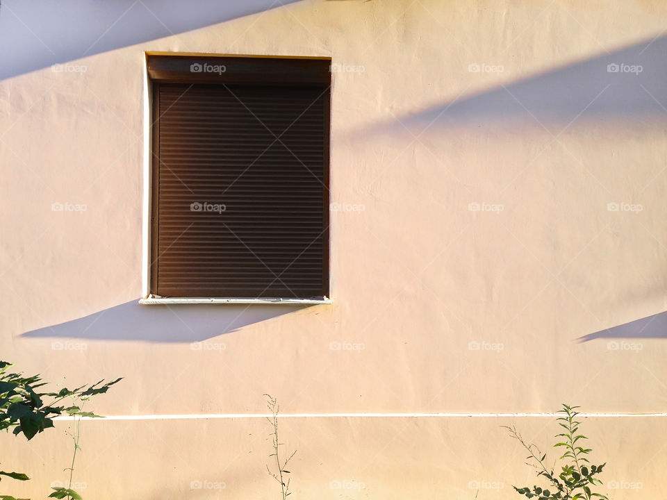 Brown Window with shadows on rustic pink pastel wall 