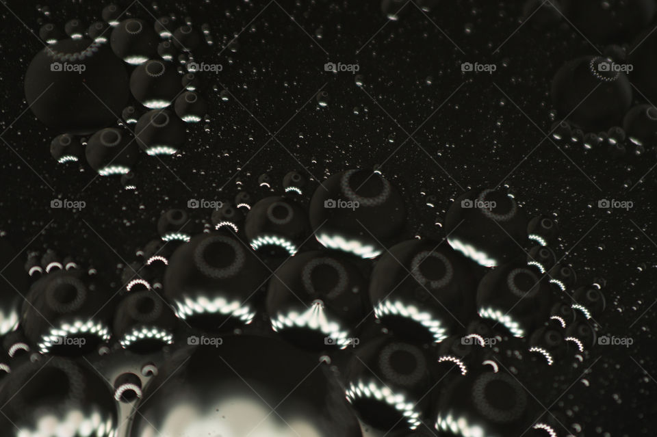 Small bubbles of vegetable oil in water close-up.