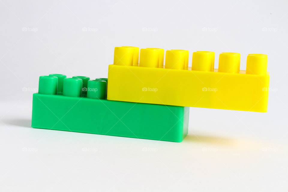 two green and yellow Lego bricks