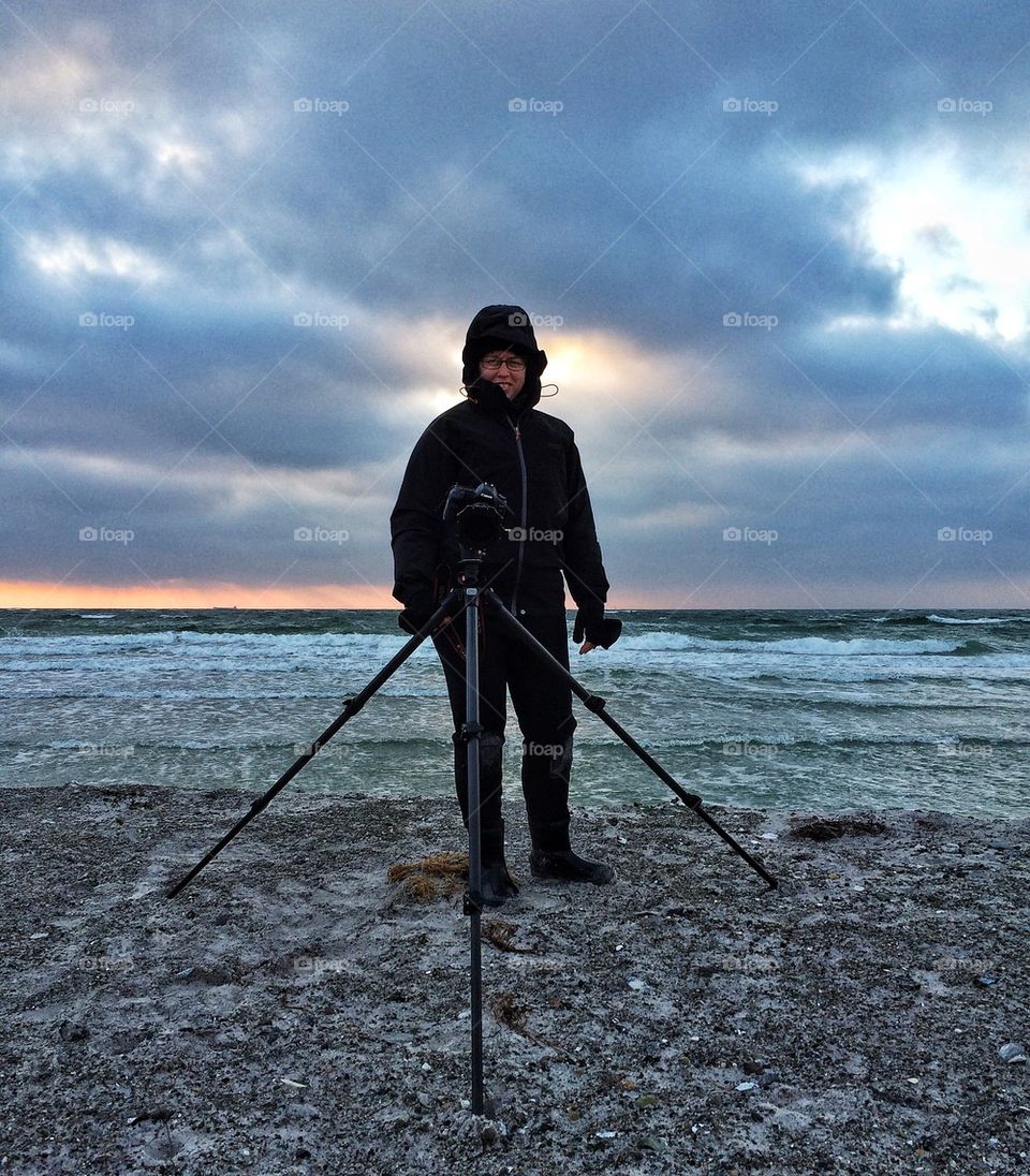 Photographer on Winter beach 