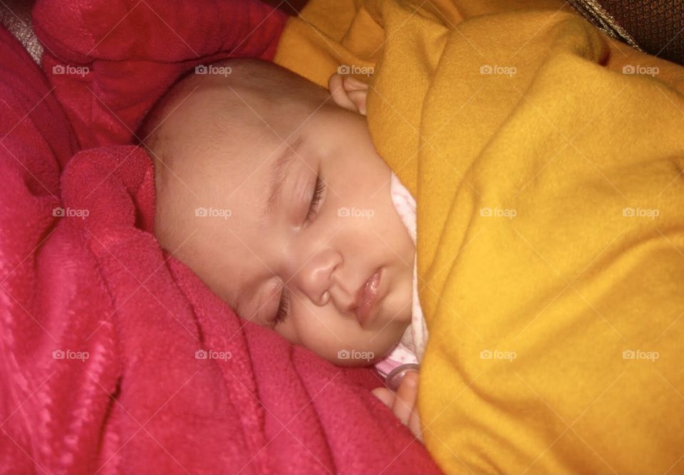 Baby sleepin on pink blanket