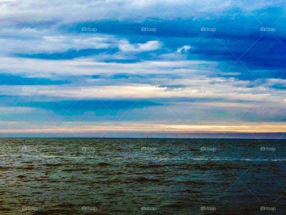 Sunset over the water with clot