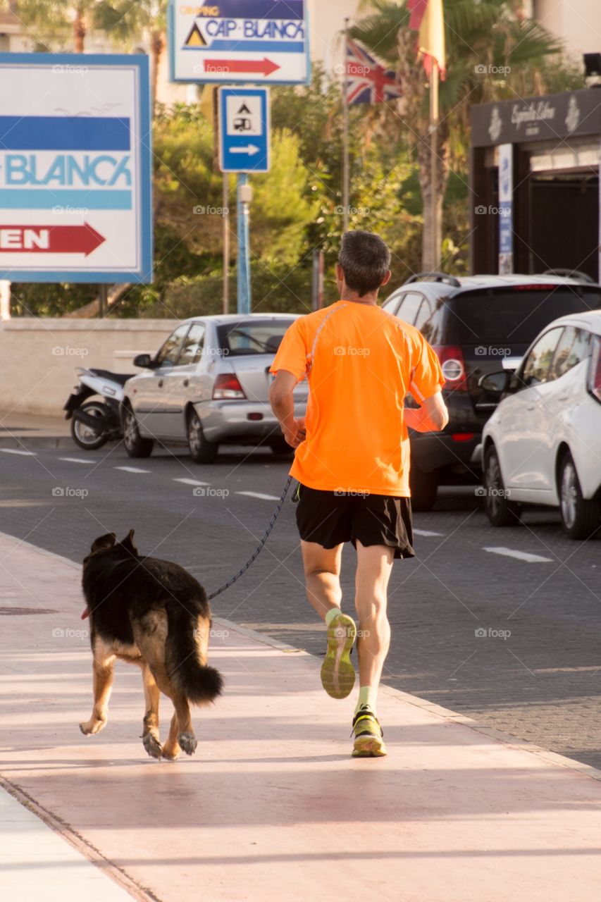 Jogging with your best friend on the boulevard of alfaz del pi