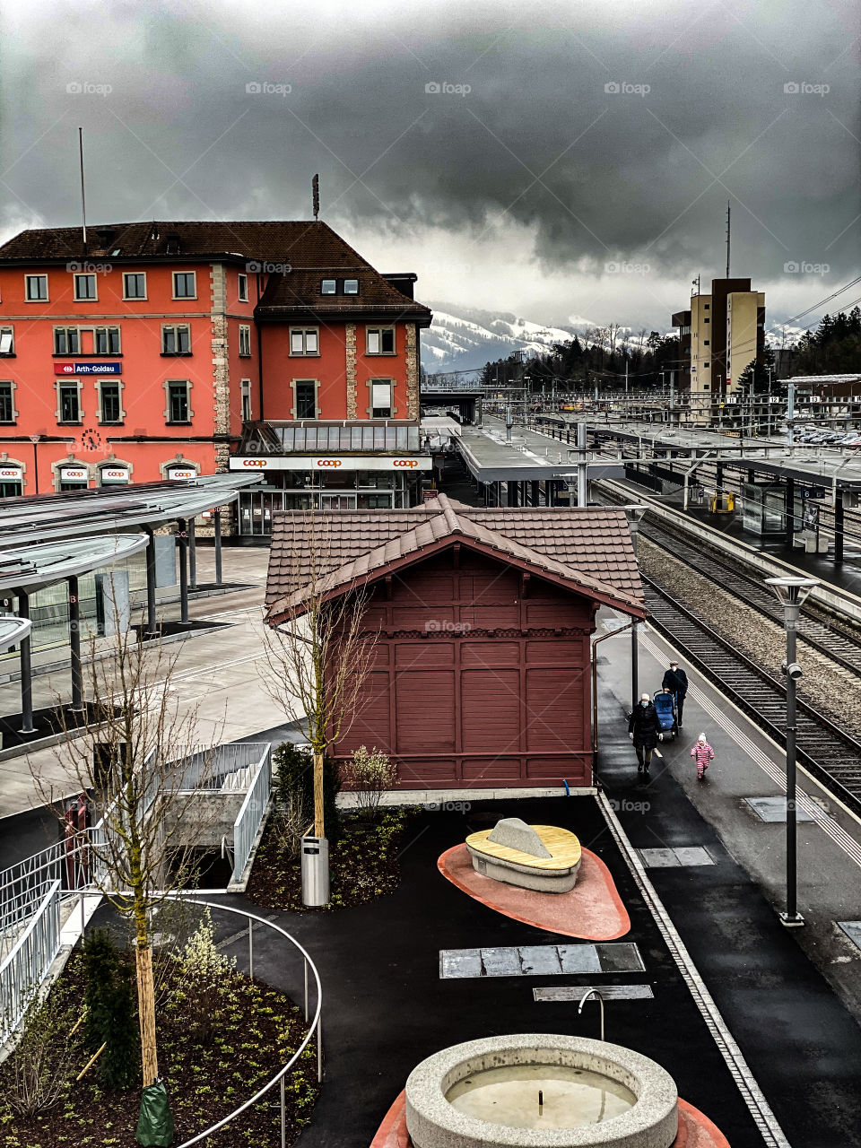 Swiss beauties, Swiss mountains, clouds floating over the Alps, railway, stop, bus, beautiful painted building, road