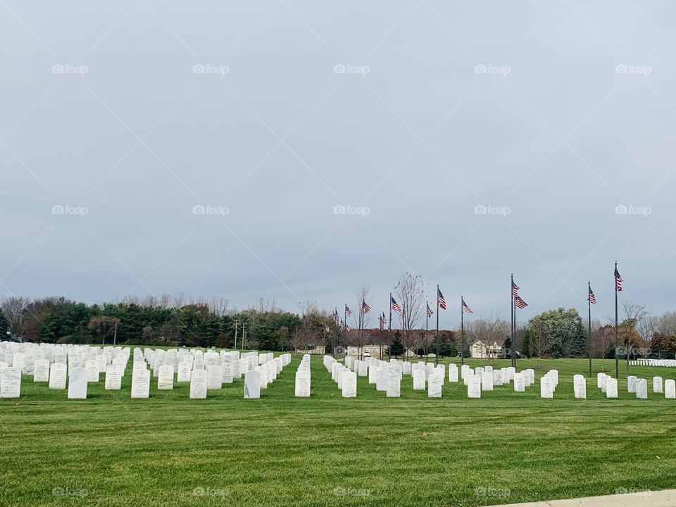 Rows of white head stones at military cemetery 