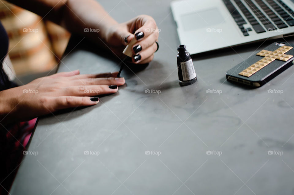 Woman painting her nails 