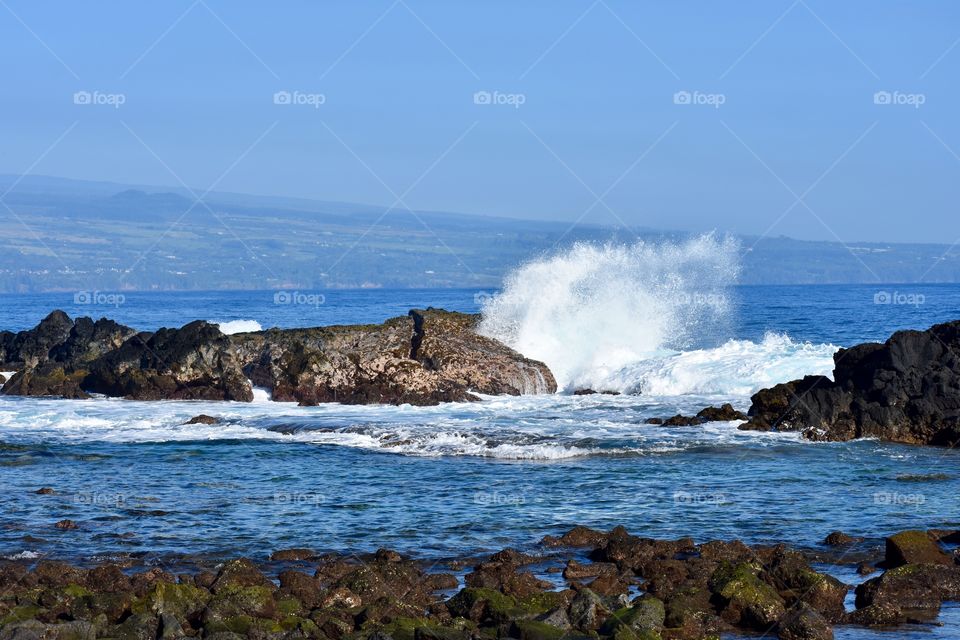 Big splash on the lava rock at Richardson Ocean Park in Hilo Hawaii.