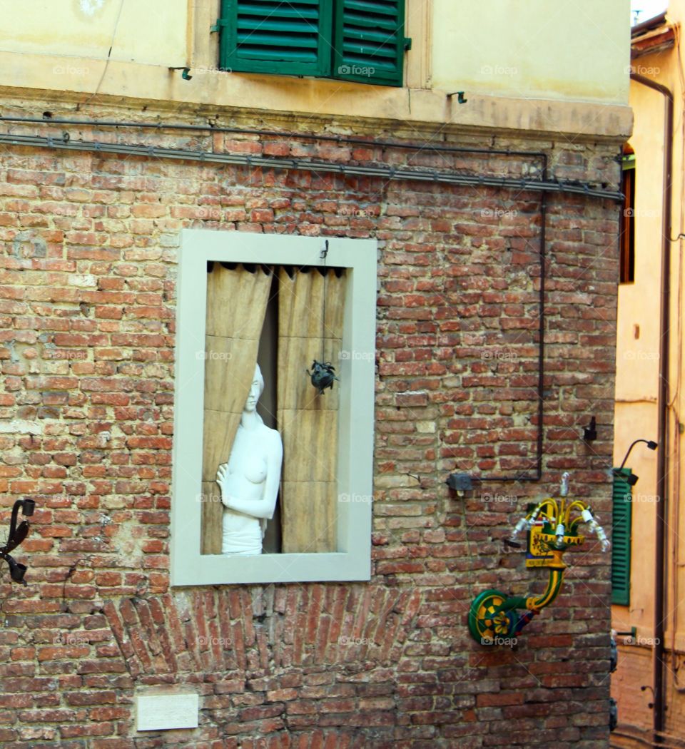 Manikin in a window in Siena Italy 