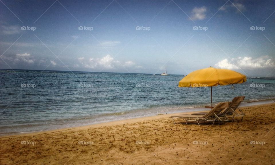 Deck chairs on empty beach