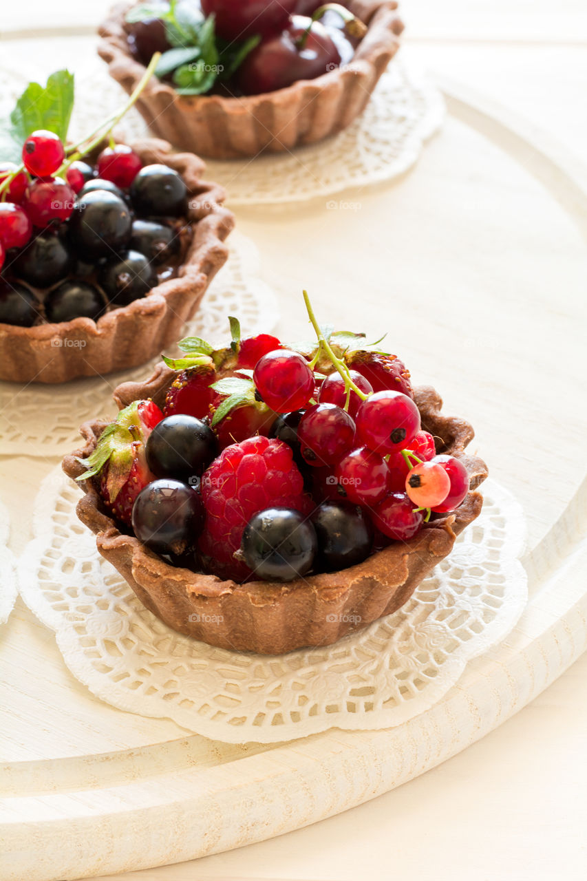 Homemade chocolate mini tarts with berries