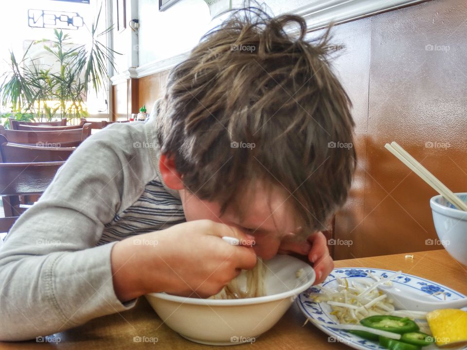 Young Boy Slurping Soup