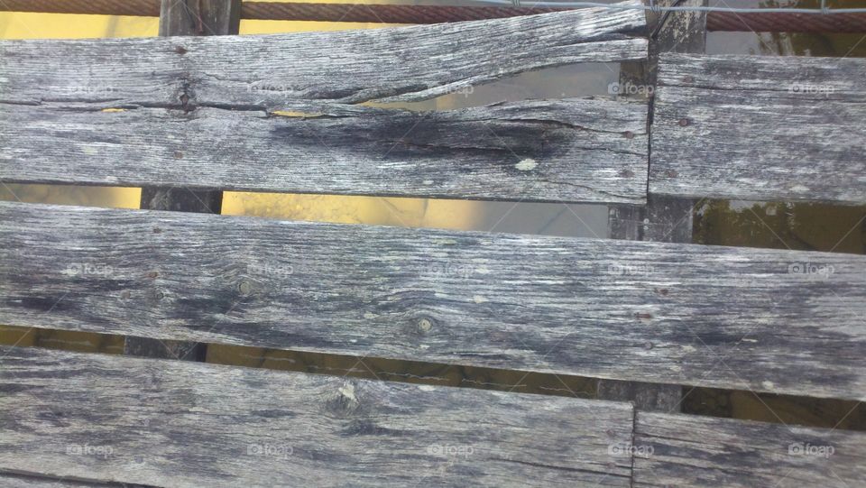 Swinging Bridge Planks. An old, rickety swinging bridge over the beginning of the New River in West Virginia