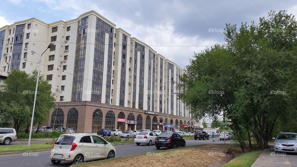 big building on a city street in cloudy day