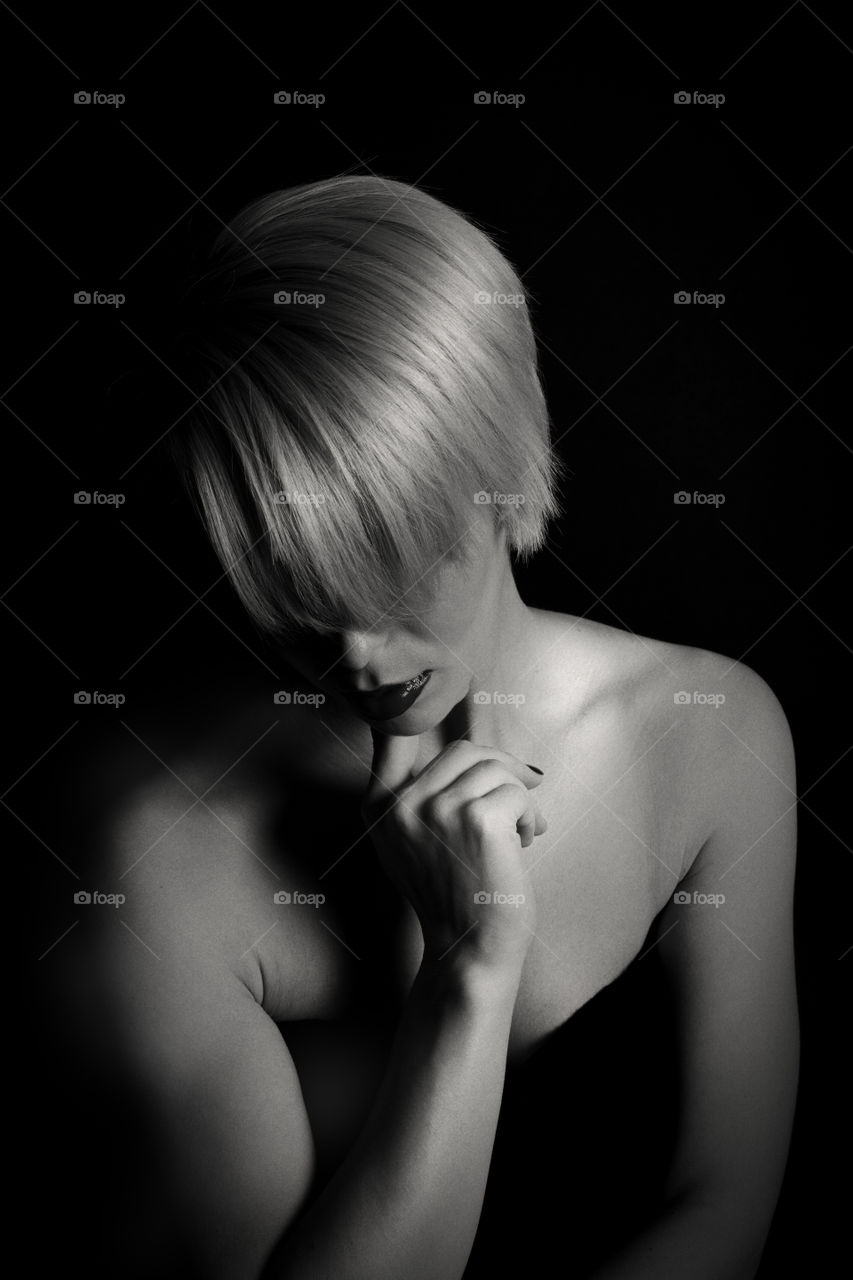 Blonde fashionable woman on black background