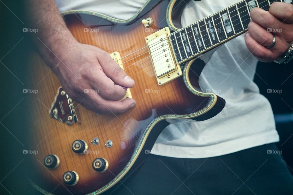 Hand playing an Electric guitar
