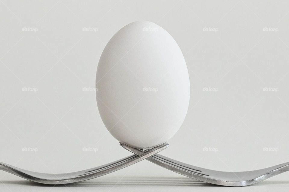 Egg balanced on fork
