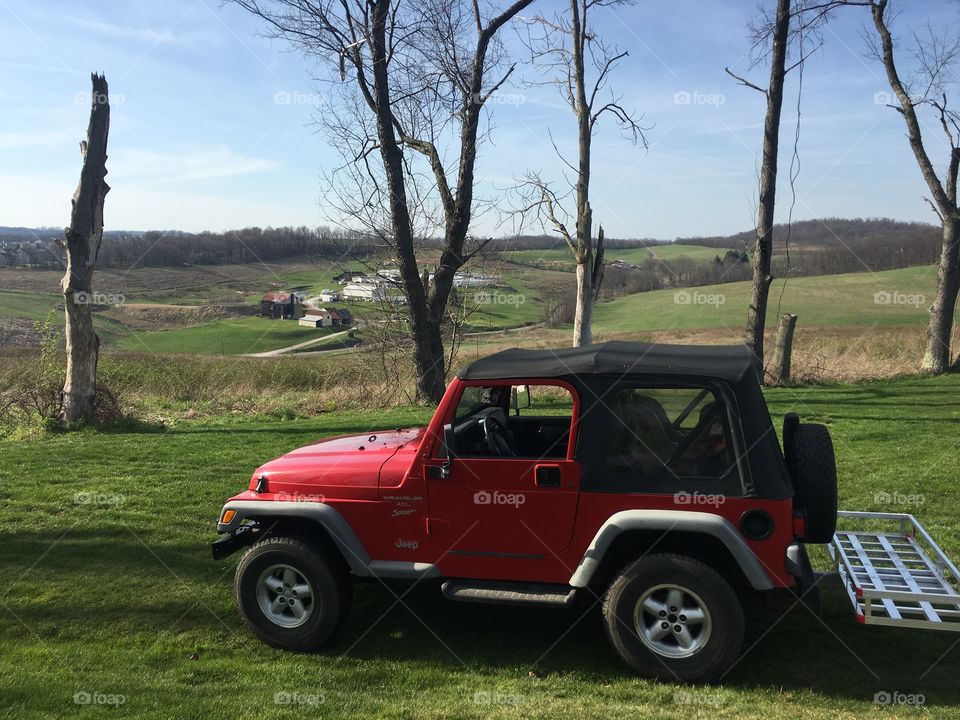 2000 red Jeep Wrangler off on a trail 