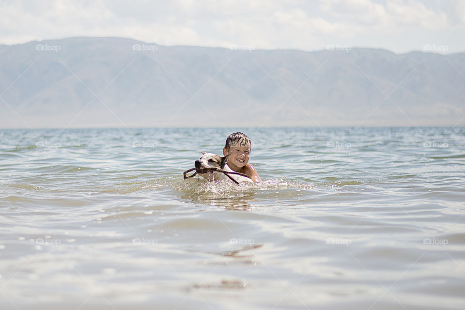 boy with dog in a water