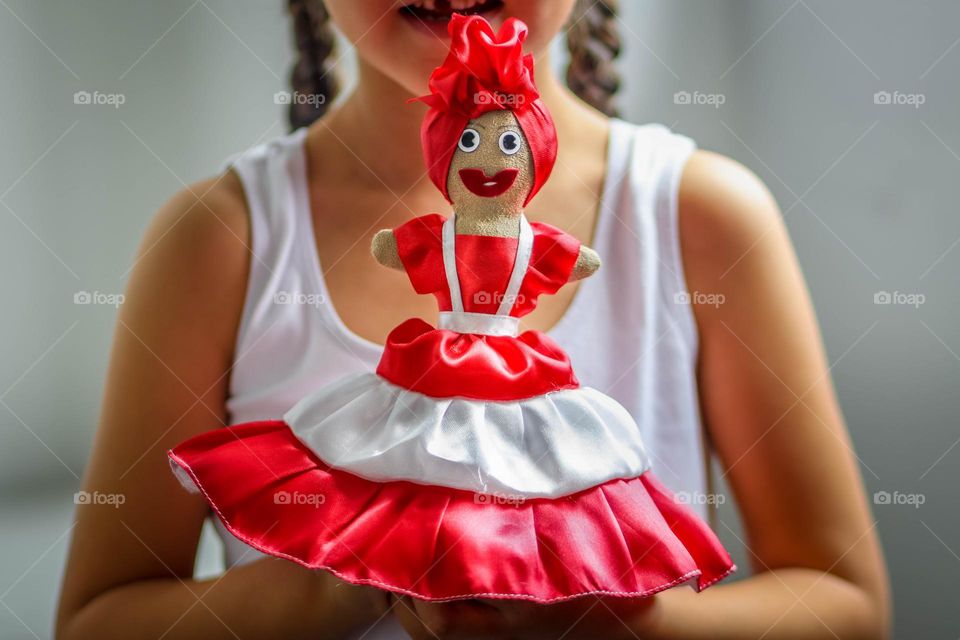 Cute little girl with a bright handmade doll