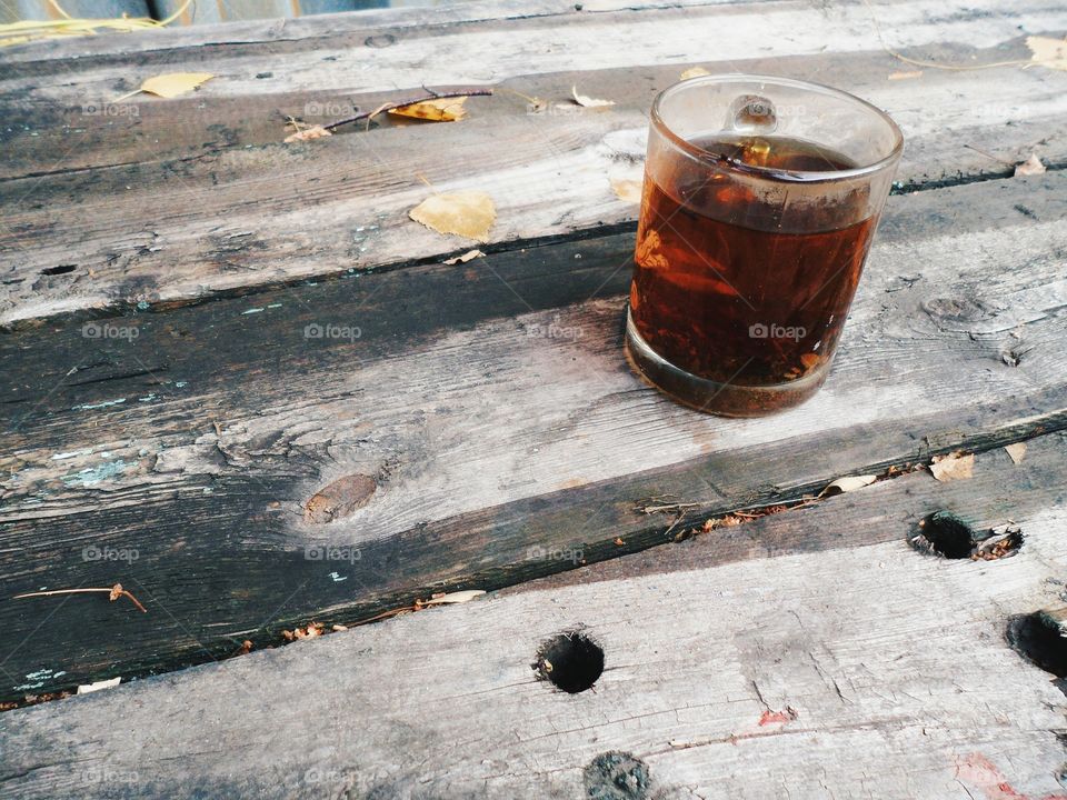 cup of black tea on an old wooden table