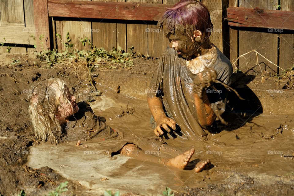Boys Playing In The Mud