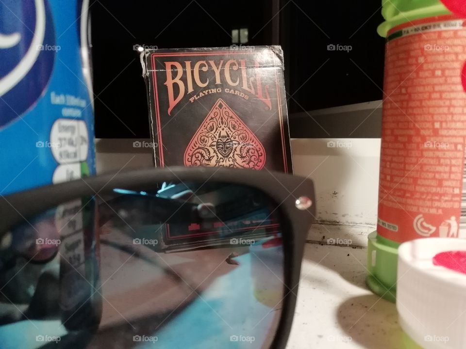 This celebrates the warm night in summer shown by the fire edition playing 
cards and the refreshing drink in the left. It also shows the anticipation for the next day to arrive shown by the sunglasses.