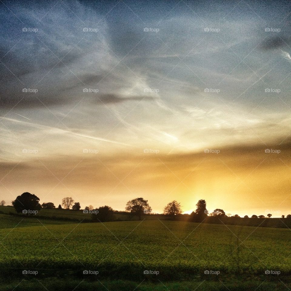 Sunset over farm fields 