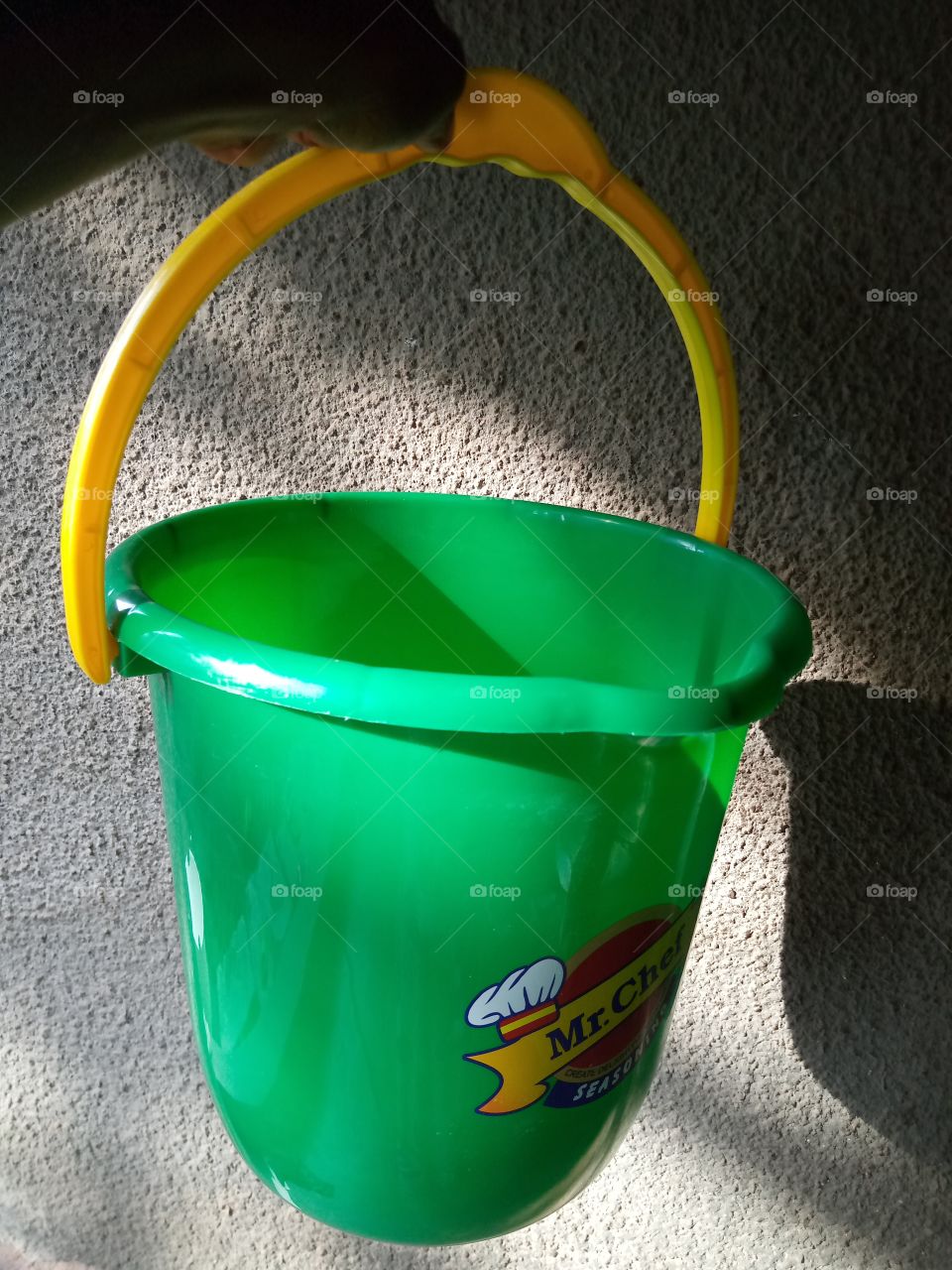 a yellow and green Mr chef seasoning rubber bucket, it can be used for multiple purposes.
