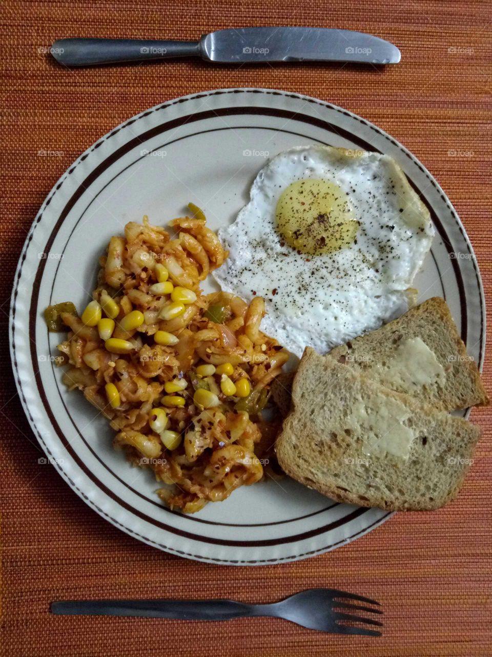 Evening light meal with pasta and half fry egg