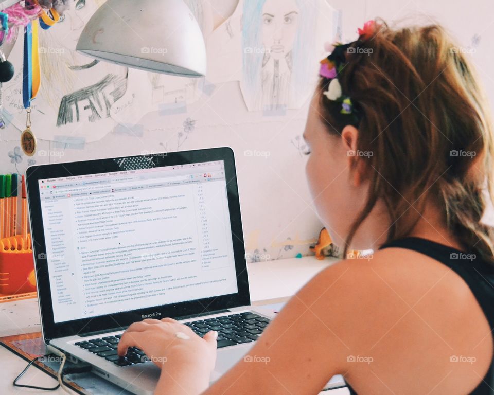 Girl doing homework on the laptop