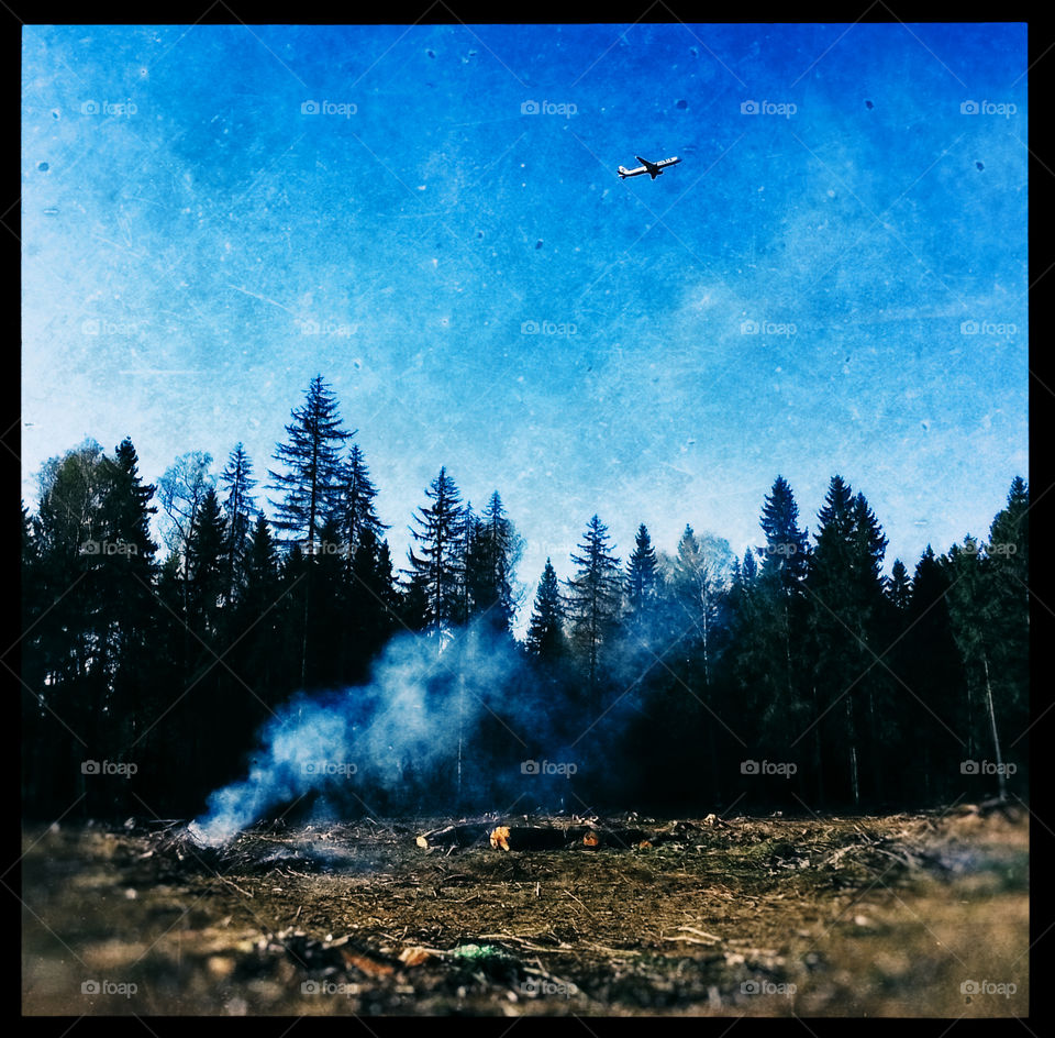 Vintage forest in fire with jet