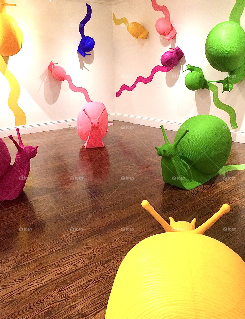 Colorful Snail sculptures crawling all over the room