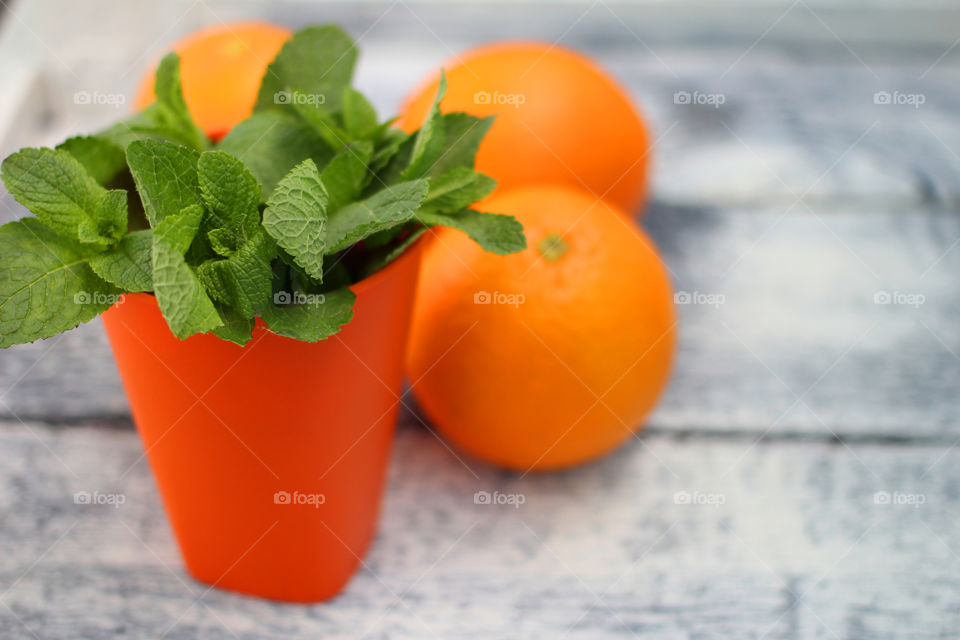 Close-up of orange fruits and mint leaves on table