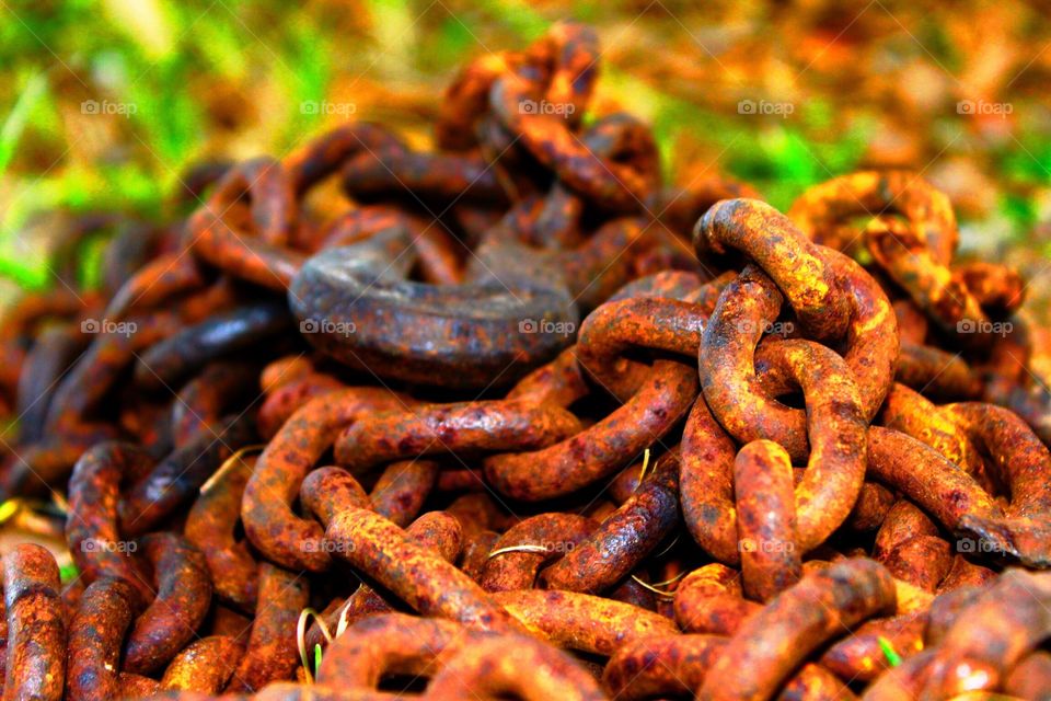 Weathered and rustic chain in a pasture