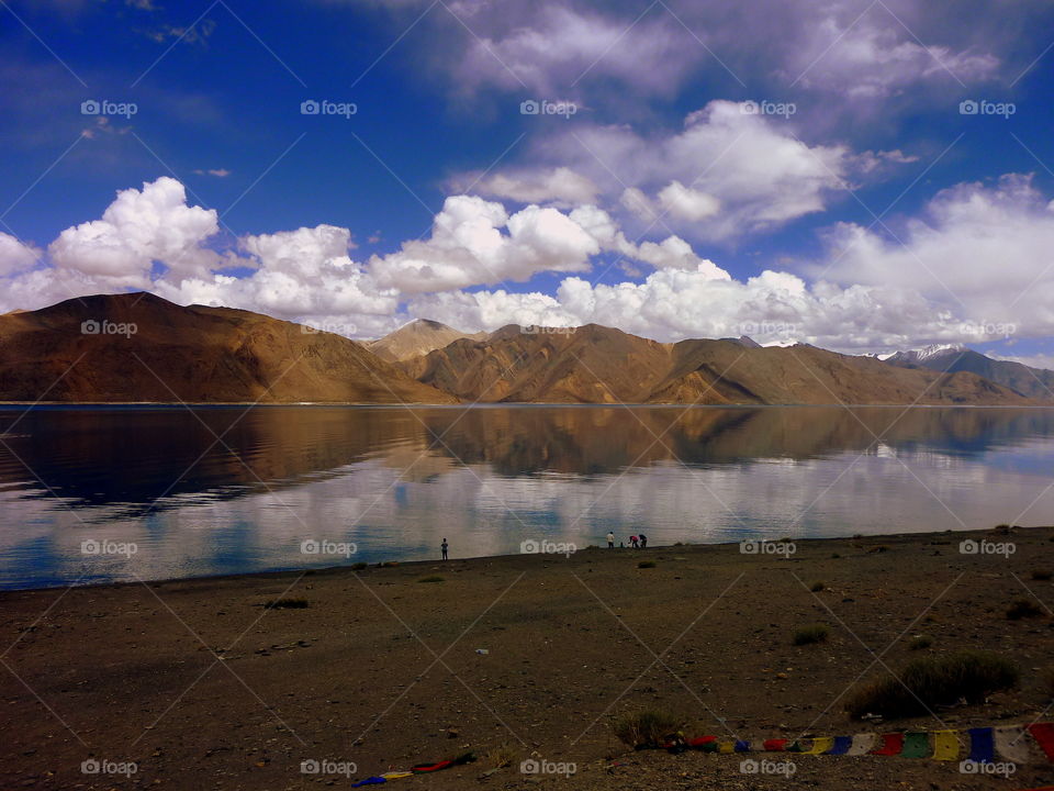 mountains, sky and clouds reflecting into the water