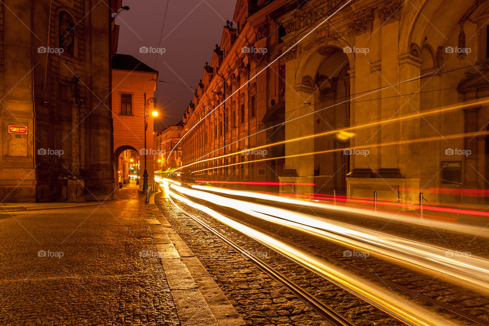 Light rays from car passing by on the night street, slow motion