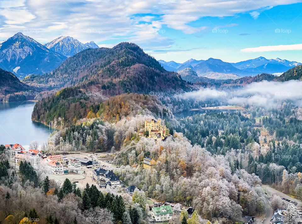 Landscape of blue sky with light snow and frost in the morning. View of mountains, lake and castle in the morning in Bavaria of Germany