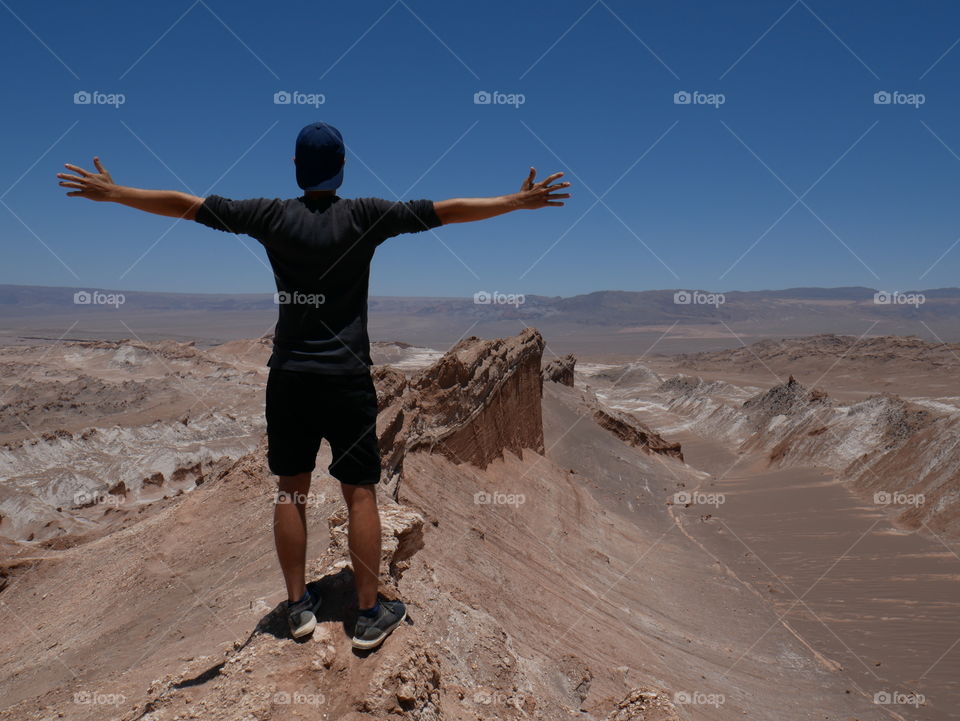 A man enjoying the view from a hike in moon valley, Chile