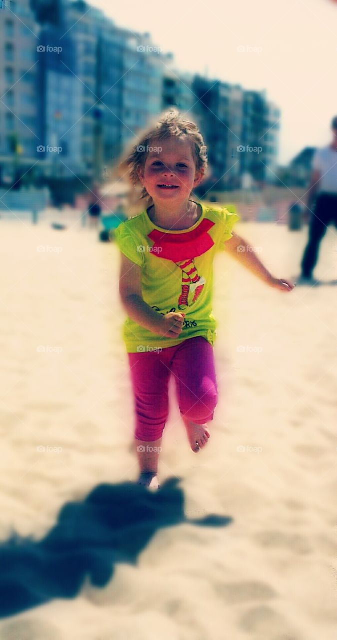My cute daughter running on the beach