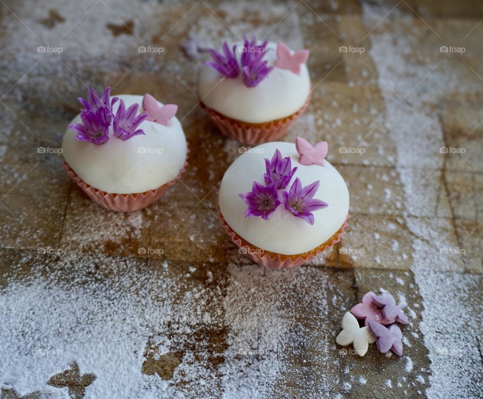 Elevated view of cupcakes decorated with flowers