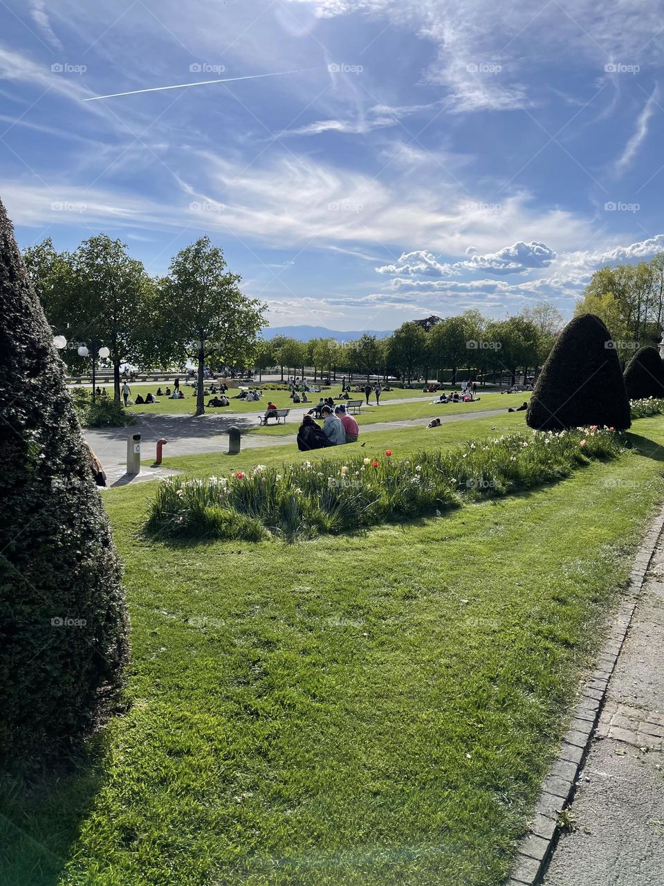 People enjoying sunshine and fresh air at a city park in the spring, Lausanne city park 