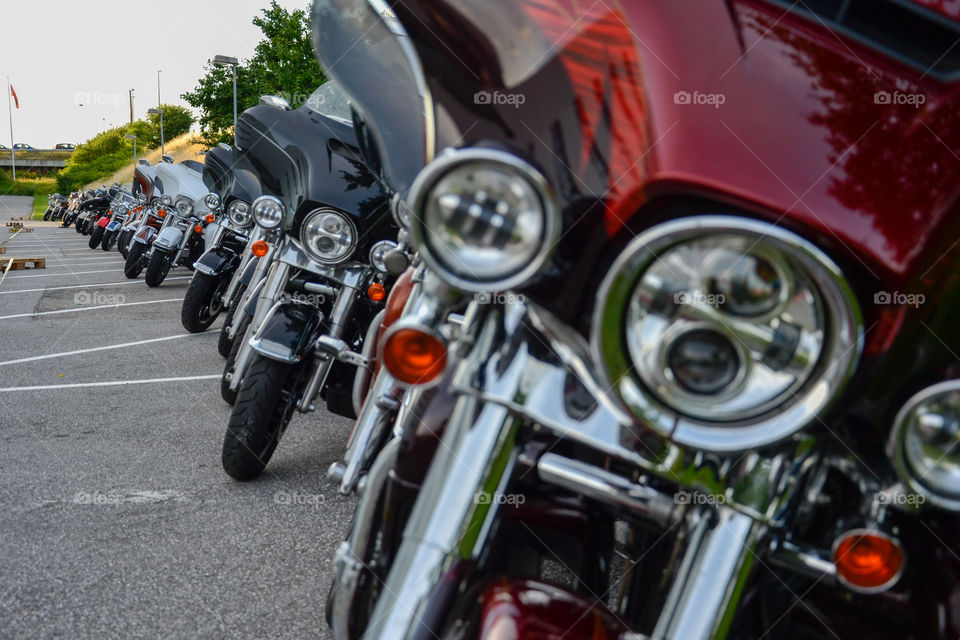 a large collection of motorcycles parked outside a hotel in Denmark.