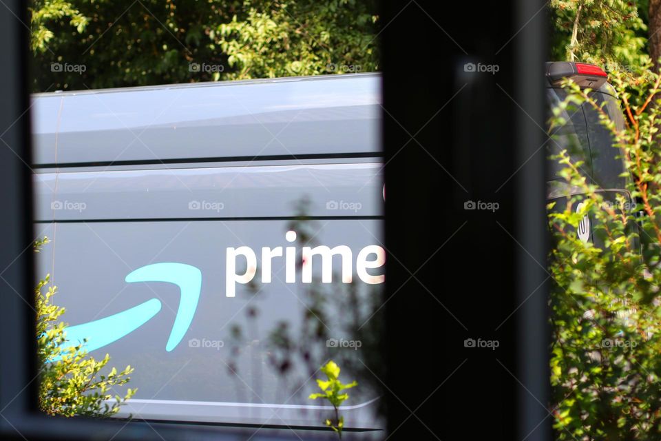 Looking out the window at the delivery by a prime Amazon van