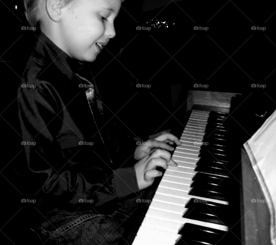 Close-up of a boy playing piano