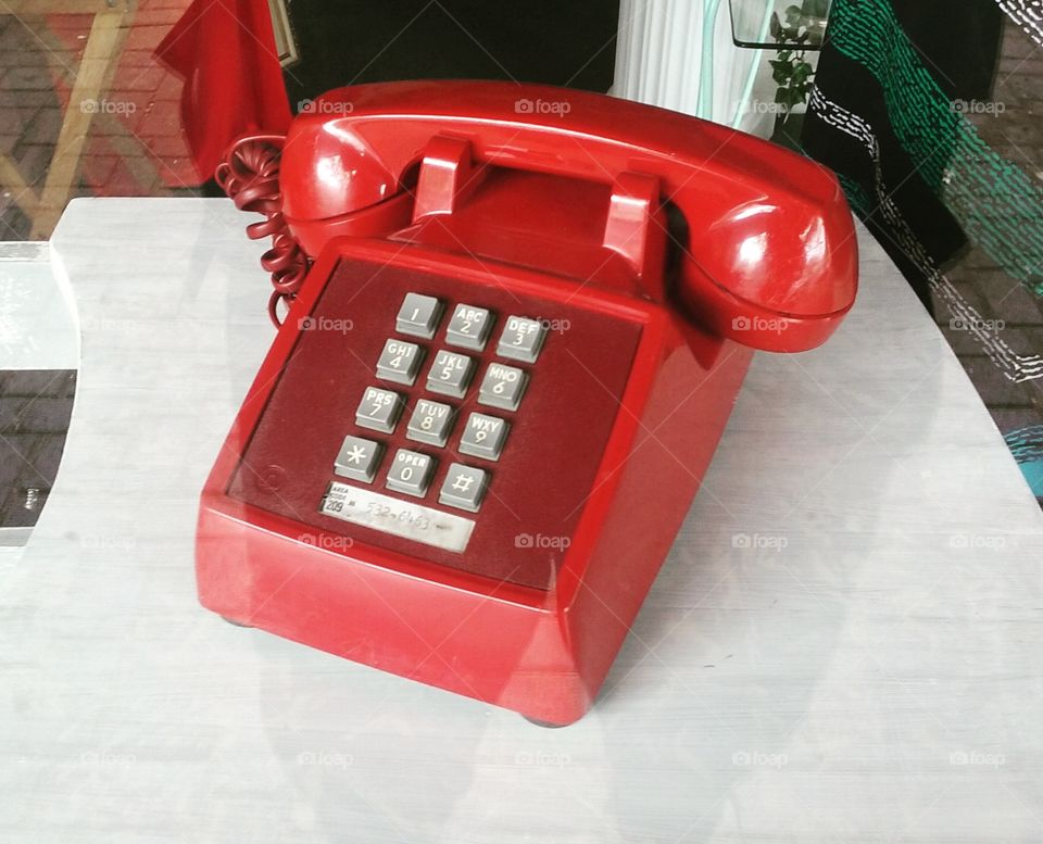 Bright Red Touchtone Telephone in a Window Display