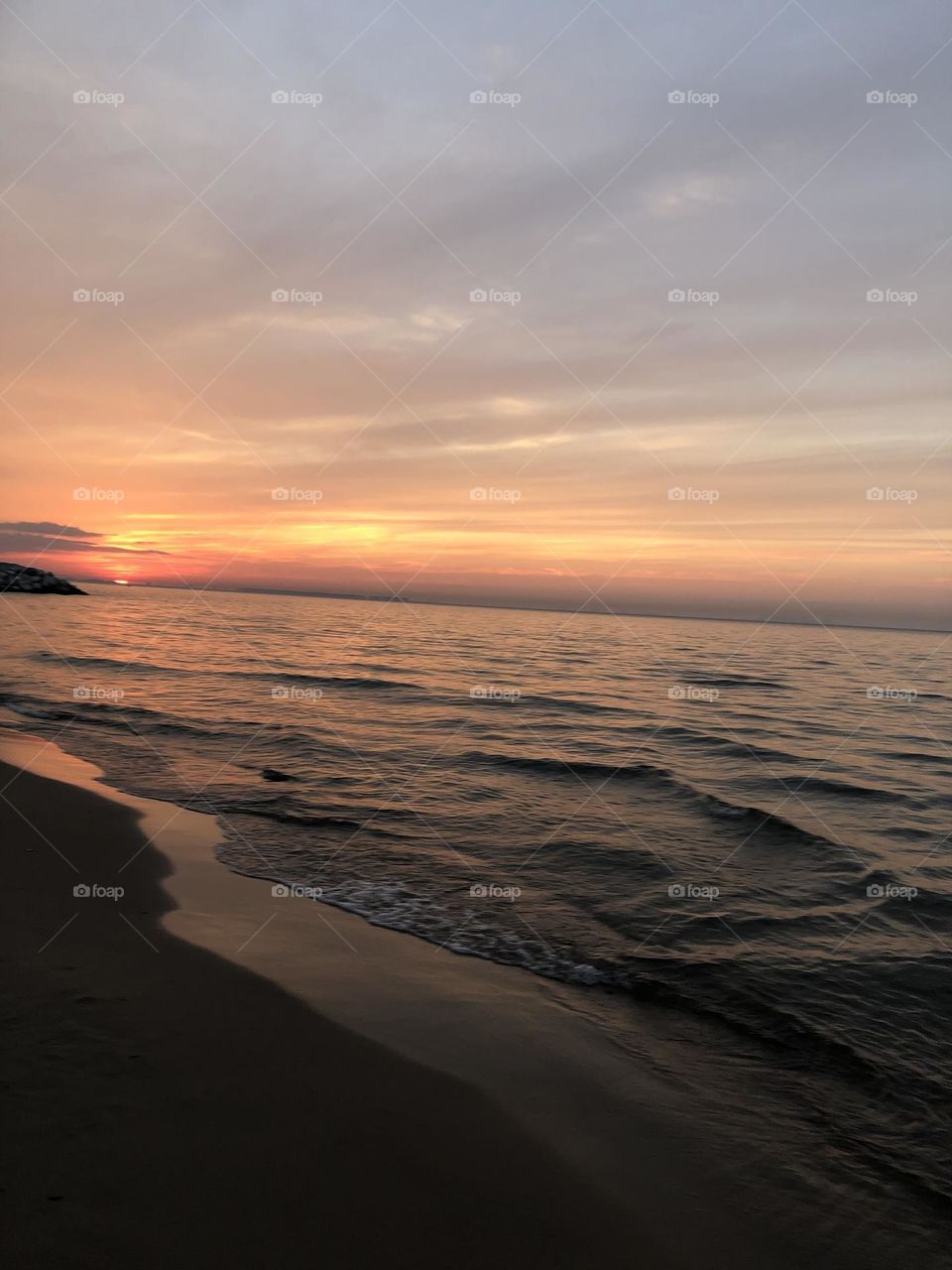 Sitting on the shore watching the waves cleaning the shoreline, with the waves going back and forth the waves