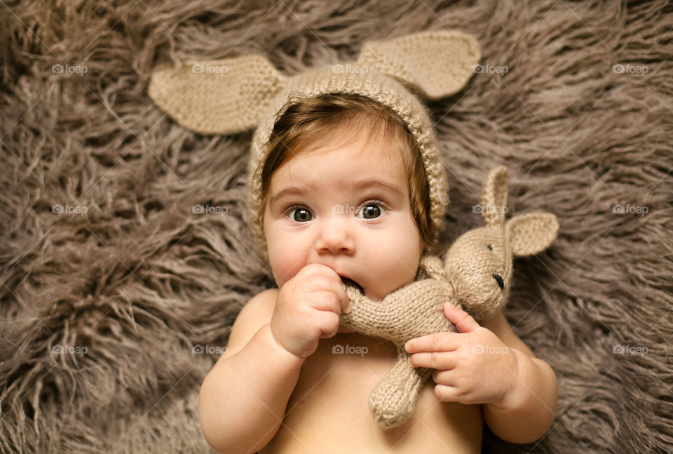 Portrait of baby playing with toy