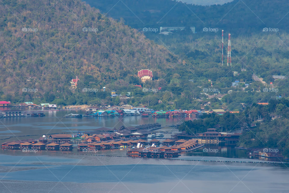 The beauty inside the dam and the houseboat on the bright sky at Sri Nakarin dam , Kanchana buri in Thailand.